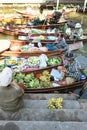 AMPHAWA Ã¢â¬â APRIL 29: Wooden boats are loaded with fruits from the orchards at Tha kha floating market Royalty Free Stock Photo